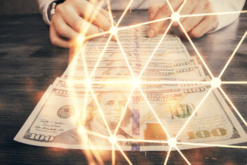Fototapeta na wymiar Multi exposure of social network theme drawing hologram and USA dollars bills and man hands.
