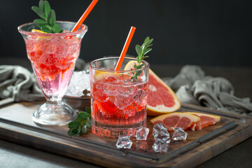 Fruit cocktail, in a glass with natural healthy fruits on a table with kitchen accessories.