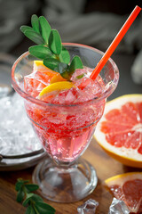 Cocktail in a glass with fruit on an old background.