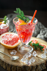 Refreshing summer alcoholic cocktail with crushed ice and citrus fruits