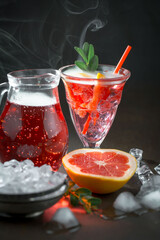Cocktail in a glass with fruit on an old background.