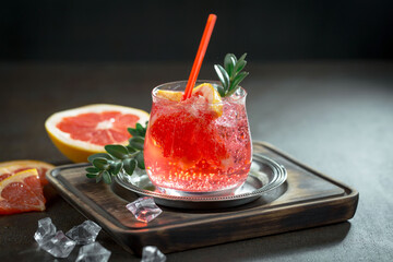 Fruit cocktail, in a glass with natural healthy fruits on a table with kitchen accessories.