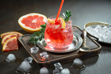 Fruit cocktail, in a glass with natural healthy fruits on a table with kitchen accessories.
