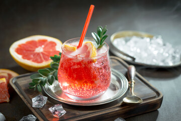 Cocktail in a glass with fruit on an old background.