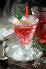 Cocktail in a glass with fruit on an old background.