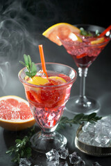 Fruit cocktail, in a glass with natural healthy fruits on a table with kitchen accessories.