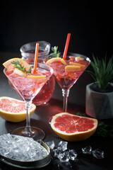 Fruit cocktail, in a glass with natural healthy fruits on a table with kitchen accessories.