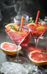 Fruit cocktail, in a glass with natural healthy fruits on a table with kitchen accessories.