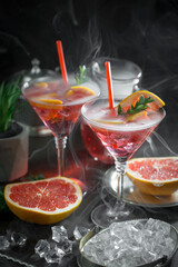 Fruit cocktail, in a glass with natural healthy fruits on a table with kitchen accessories.