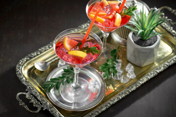 Refreshing summer alcoholic cocktail with crushed ice and citrus fruits