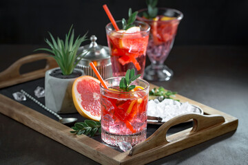 Cocktail in a glass with fruit on an old background.