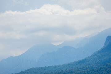 Mountains after rain. Water evaporating off the forest. Forest covered by low clouds.