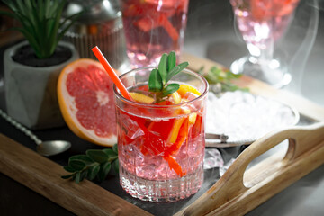 Cocktail in a glass with fruit on an old background.