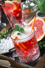 Refreshing summer alcoholic cocktail with crushed ice and citrus fruits
