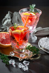 Fruit cocktail, in a glass with natural healthy fruits on a table with kitchen accessories.