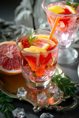 Fruit cocktail, in a glass with natural healthy fruits on a table with kitchen accessories.