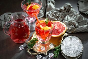 Fruit cocktail, in a glass with natural healthy fruits on a table with kitchen accessories.