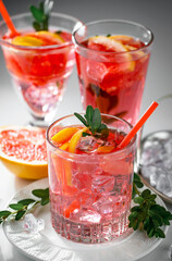 Fruit cocktail, in a glass with natural healthy fruits on a table with kitchen accessories.