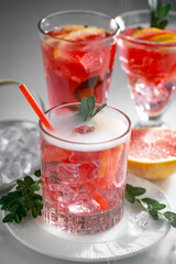 Fruit cocktail, in a glass with natural healthy fruits on a table with kitchen accessories.