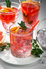Fruit cocktail, in a glass with natural healthy fruits on a table with kitchen accessories.