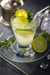 Fruit cocktail, in a glass with natural healthy fruits on a table with kitchen accessories.