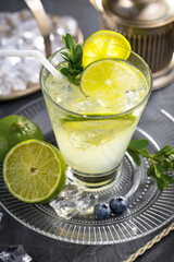 Fruit cocktail, in a glass with natural healthy fruits on a table with kitchen accessories.