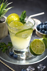 Cocktail in a glass with fruit on an old background.