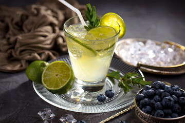 Fruit cocktail, in a glass with natural healthy fruits on a table with kitchen accessories.