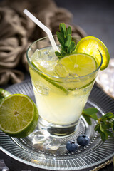 Fruit cocktail, in a glass with natural healthy fruits on a table with kitchen accessories.