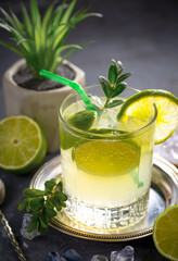 Cocktail in a glass with fruit on an old background.