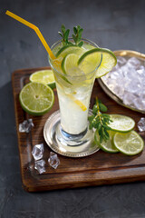 Cocktail in a glass with fruit on an old background.