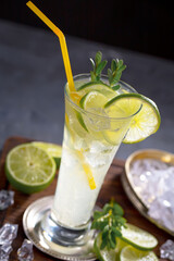 Fruit cocktail, in a glass with natural healthy fruits on a table with kitchen accessories.
