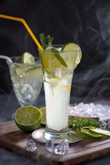 Fruit cocktail, in a glass with natural healthy fruits on a table with kitchen accessories.