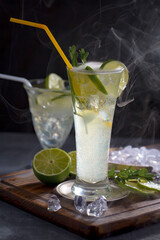 Fruit cocktail, in a glass with natural healthy fruits on a table with kitchen accessories.
