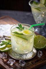 Fruit cocktail, in a glass with natural healthy fruits on a table with kitchen accessories.