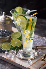 Fruit cocktail, in a glass with natural healthy fruits on a table with kitchen accessories.