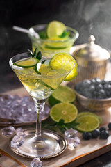 Fruit cocktail, in a glass with natural healthy fruits on a table with kitchen accessories.