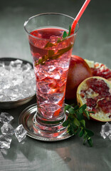 Fruit cocktail, in a glass with natural healthy fruits on a table with kitchen accessories.