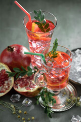 Fruit cocktail, in a glass with natural healthy fruits on a table with kitchen accessories.