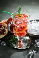 Cocktail in a glass with fruit on an old background.