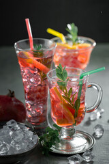 Fruit cocktail, in a glass with natural healthy fruits on a table with kitchen accessories.