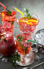 Fruit cocktail, in a glass with natural healthy fruits on a table with kitchen accessories.