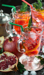 Fruit cocktail, in a glass with natural healthy fruits on a table with kitchen accessories.