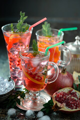 Fruit cocktail, in a glass with natural healthy fruits on a table with kitchen accessories.