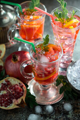 Cocktail in a glass with fruit on an old background.