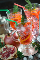 Fruit cocktail, in a glass with natural healthy fruits on a table with kitchen accessories.