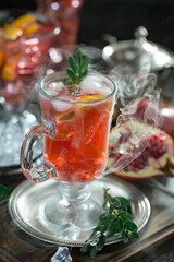 Fruit cocktail, in a glass with natural healthy fruits on a table with kitchen accessories.