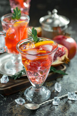 Cocktail in a glass with fruit on an old background.