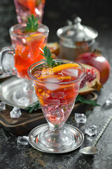 Fruit cocktail, in a glass with natural healthy fruits on a table with kitchen accessories.