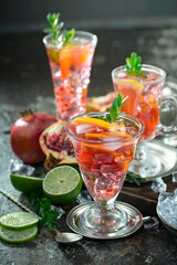 Fruit cocktail, in a glass with natural healthy fruits on a table with kitchen accessories.